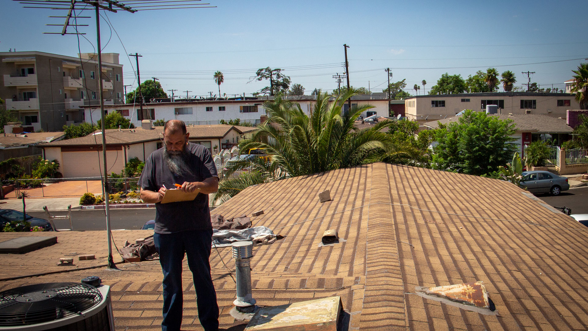 Joe Sandi inspecting a roof